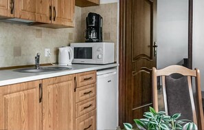 Fridge, microwave, coffee/tea maker, cookware/dishes/utensils