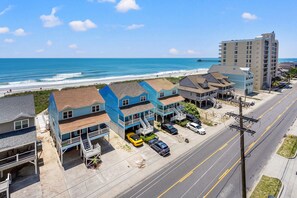 A coastal hotel with multiple stories, a beach view, and a parking area with cars. - Close to beach, beautiful marsh views, fitness center, indoor/outdoor pools, hot tub (North Myrtle Beach)