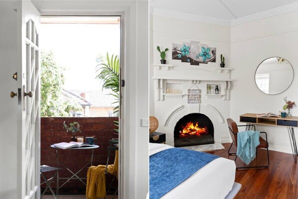 A room with a fireplace, a desk, a chair, and a bed.