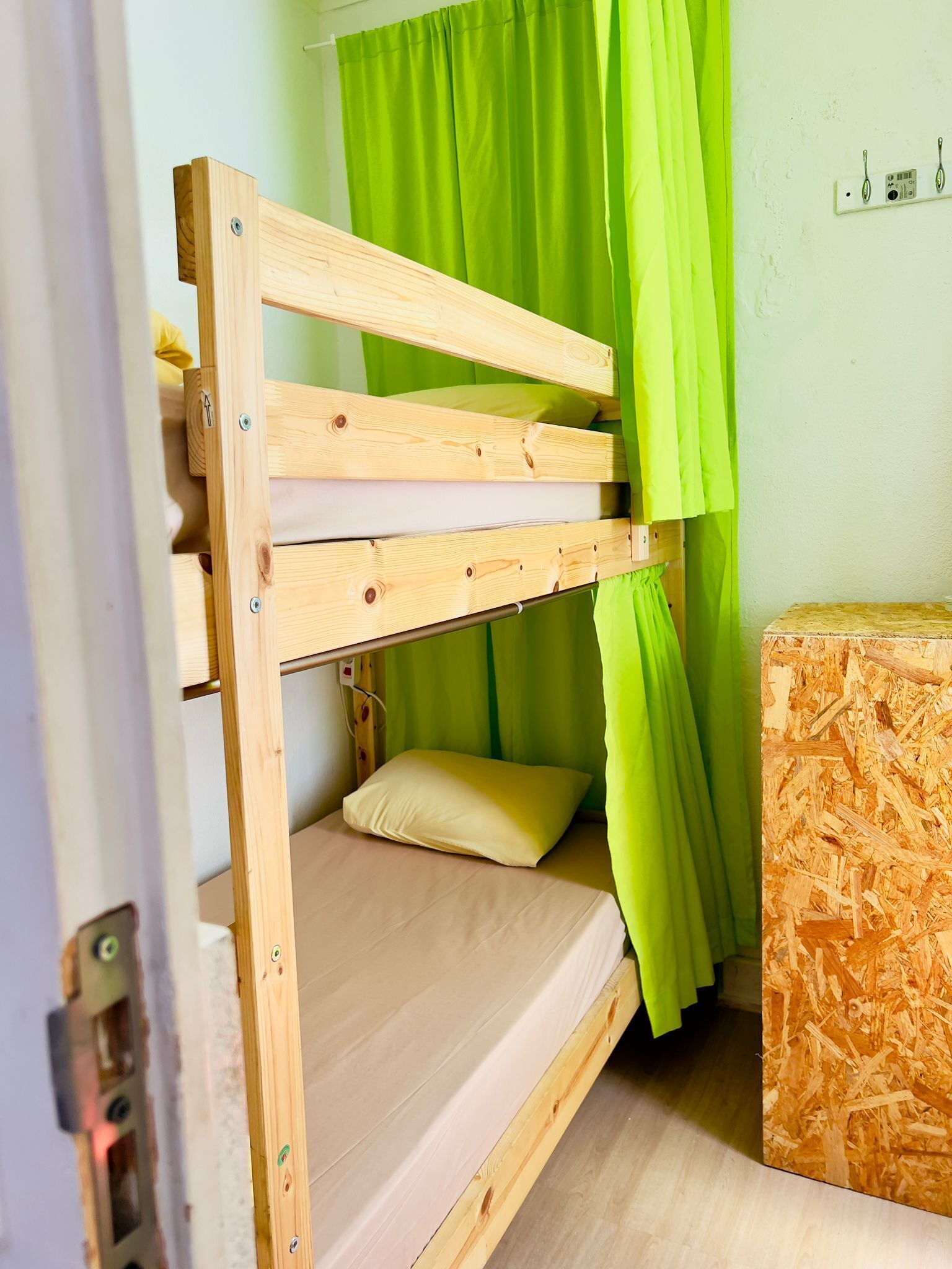 A bunk bed with a wooden frame and a mattress.