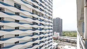 A high-rise building with a wavy facade and multiple balconies. - The Wave Residence By I Housing (Malacca City)