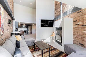 A modern living space with a sofa set, a coffee table, and a fireplace.