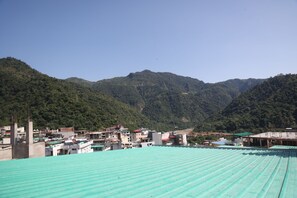 Un paysage montagneux avec une ville au premier plan.