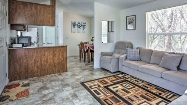 A modern living space with a kitchen, dining area, and seating area. - Blue Mountainview welcomes long stays (Mariposa)
