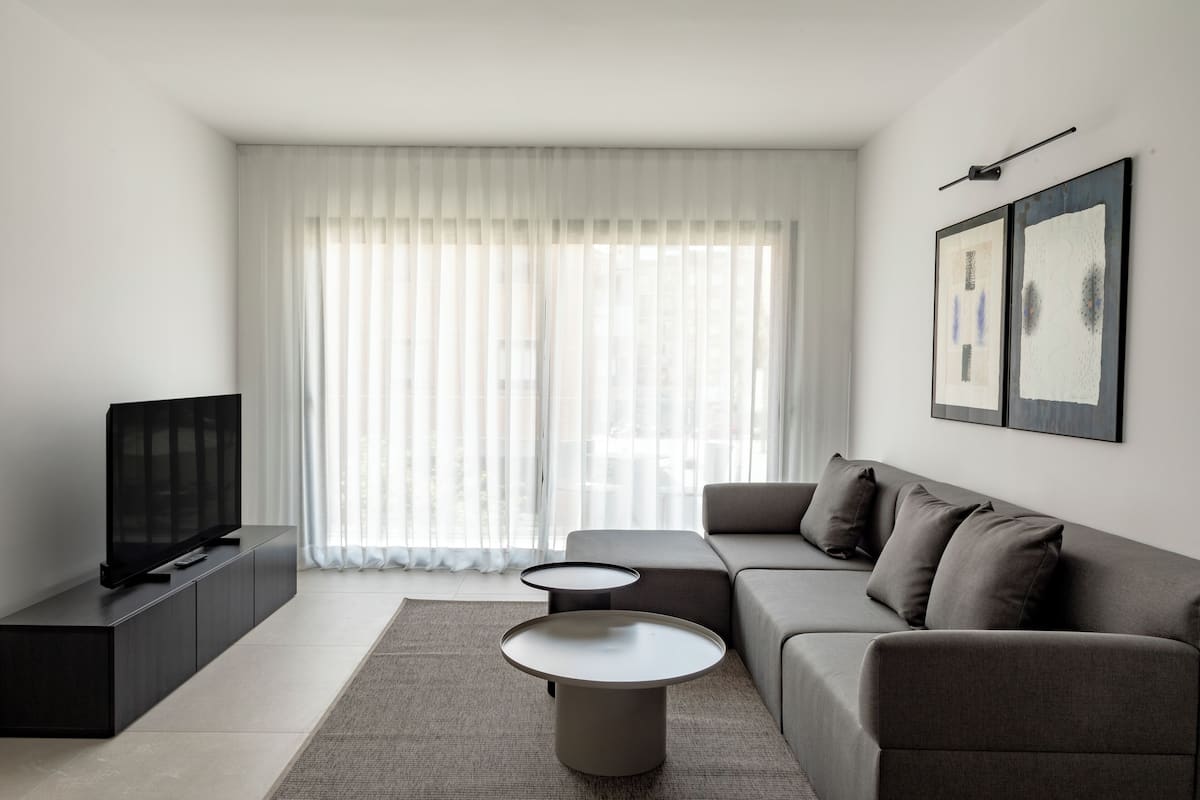Family Apartment, 3 Bedrooms, Balcony | Living area | 50-inch Smart TV with digital channels