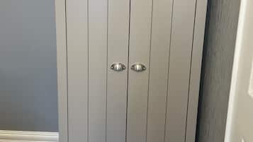 A white wardrobe with two doors and a handle on each door.