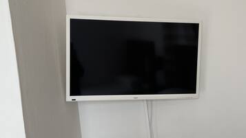 A flat-screen TV mounted on a white wall.