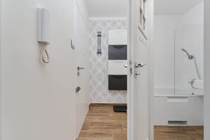 A bathroom with a shower, a toilet, and a sink.