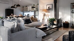 Relax in this stylish living room with a sofa, coffee table, and fireplace.