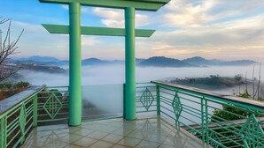 A traditional Japanese torii gate at a viewpoint overlooking mist-covered mountains. - 3 Tang May Home & Coffee (Xuan Truong - Da Lat)