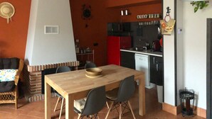 A compact living space with a dining area, a kitchen, and a small seating area.