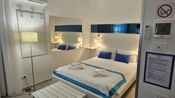 Deluxe Room, Multiple Beds, Private Bathroom, Courtyard View | 1 bedroom, in-room safe, desk, blackout drapes