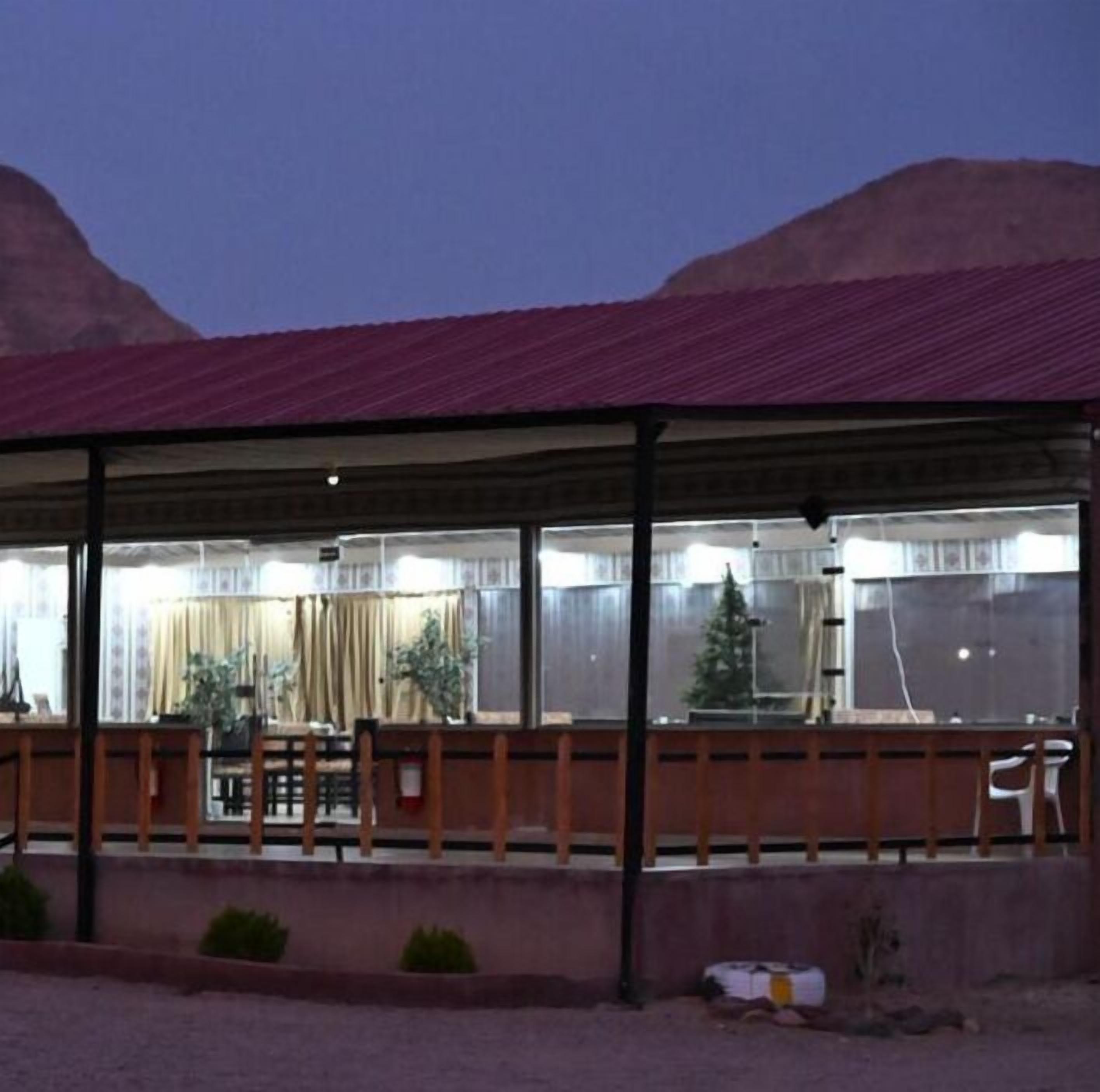A covered outdoor seating area with a view of mountains.