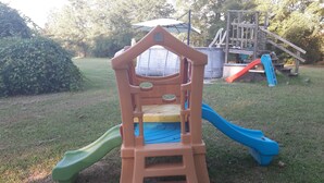 A children's play structure with a slide and climbing area. - Private, 1 Mile to Poe, 4 miles to Blue, 6 Miles to Ginnie. Tent/Camper camping (High Springs)