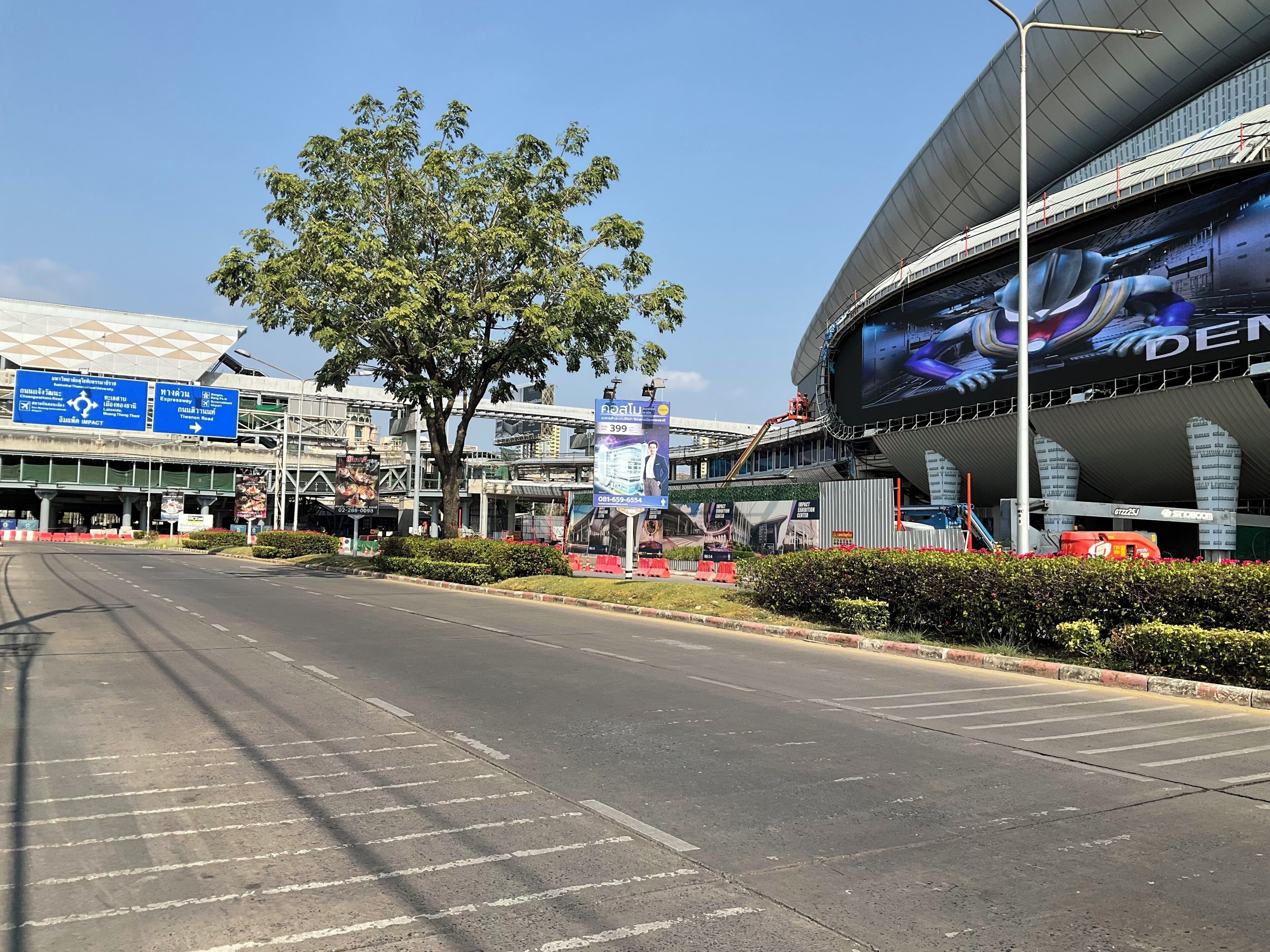 A modern building with a large digital screen displaying an image.