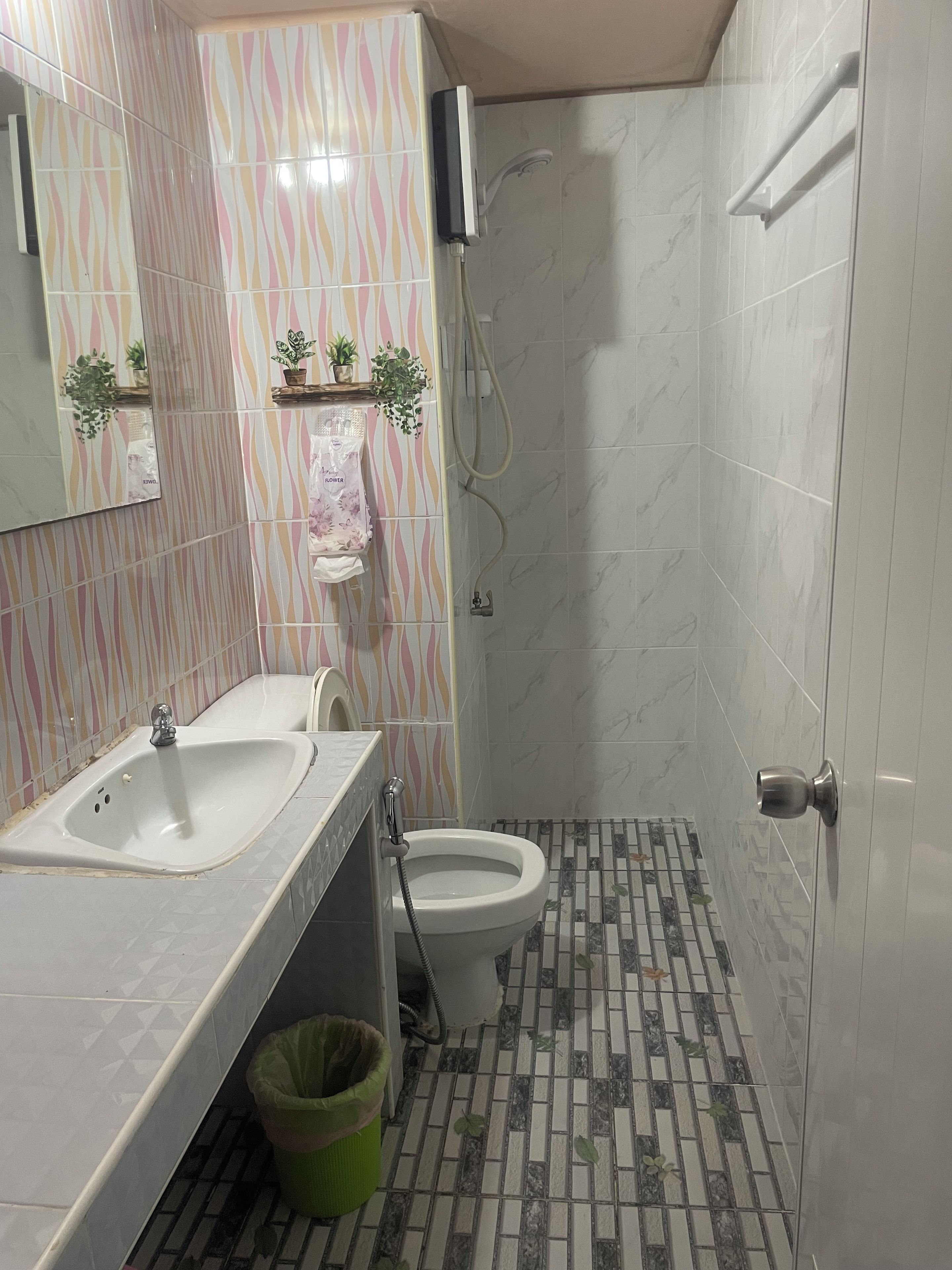 A bathroom with a sink, toilet, and shower.