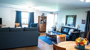 A living room with a sofa, a coffee table, a dining table with chairs, and a cabinet. - MY HAPPY PLACE - view of Ark from our farm (Williamstown)