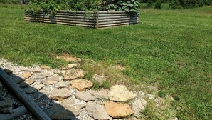 A garden with a wooden planter bed and a stone pathway. - MY HAPPY PLACE - view of Ark from our farm (Williamstown)