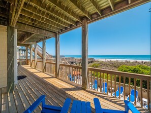 A wooden deck with blue chairs overlooking a beach. - Get Back #141 - Oceanfront w/ Private Pool, Hot Tub, Dog-friendly! (North Topsail Beach)