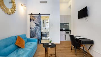 City Studio, City View | Living area | 32-inch flat-screen TV with cable channels, TV