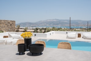 A rooftop pool area with wicker chairs, a table, and a potted plant. - Dreamy 5 BDR Antiparos pool villa  (Antiparos)