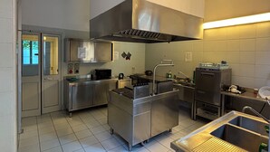 A modern kitchen with stainless steel appliances, a large island, and a built-in oven. - CiaoMi - Hostel & Long Stay - Milano Niguarda & Bicocca  (Milan)