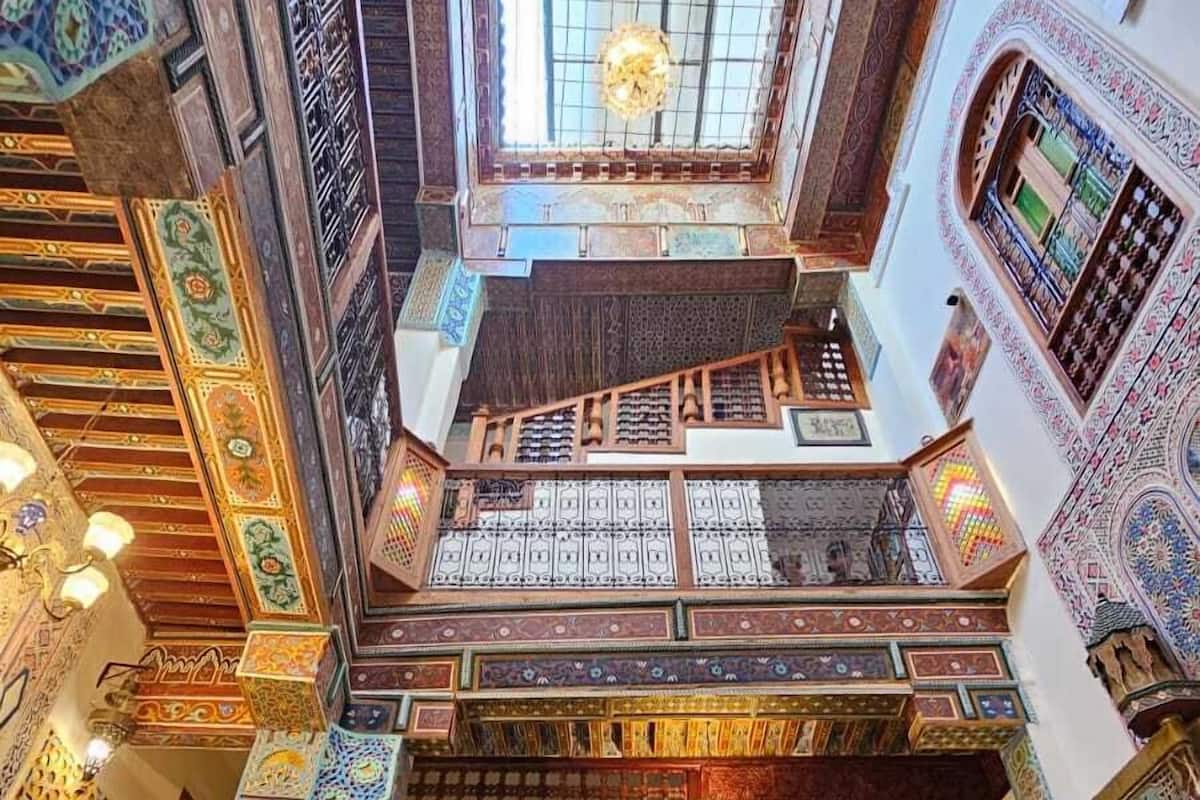A multi-level atrium with intricate tile work and a central staircase.