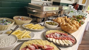 A buffet with various food items including cheese, ham, bread, and salads. - Mleczarnia Hotel Restauracja (Suchy Las)