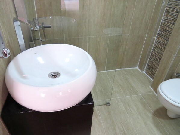 A bathroom with a white sink, a toilet, and tiled walls. - Istanberry - Luna Apartments (Istanbul)