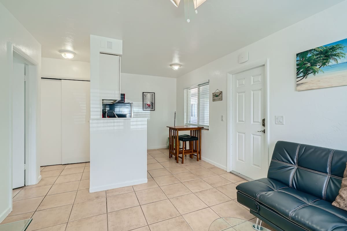 A compact living space with a kitchenette, a dining area, and a seating area.