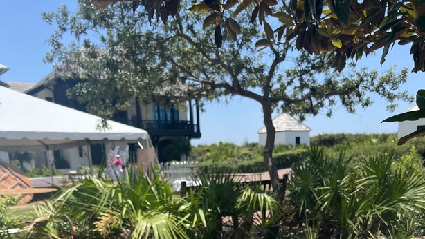 Two people holding bowls of fruit salad with a wooden deck and greenery in the background. - Beachside Dreams, at Boutique Beachside Villas, Newly Renovated and Decorated (Santa Rosa Beach)