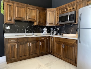 Signature Apartment | Private kitchen | Full-size fridge, microwave, stovetop, coffee/tea maker