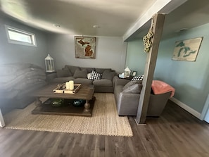 Relax in this stylish living room with a gray sofa, coffee table, and woven rug.