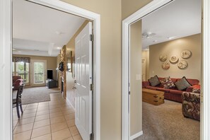 Enter a cozy living space with a comfortable sofa, wooden chest, and clocks on the wall.