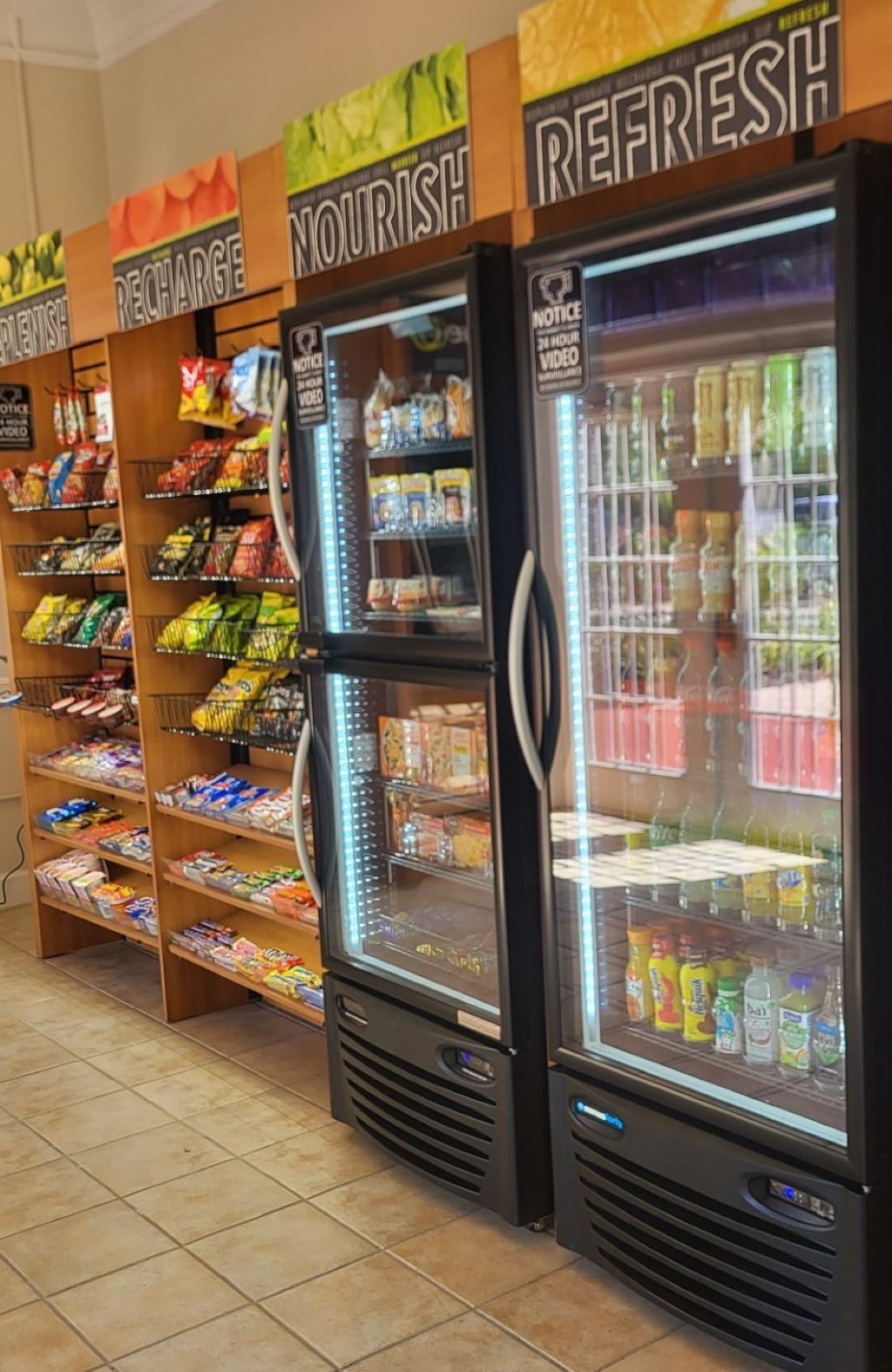 A refrigerated display area with shelves stocked with snacks and beverages.