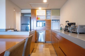 A modern kitchen with a built-in oven, a coffee machine, and a dishwasher.