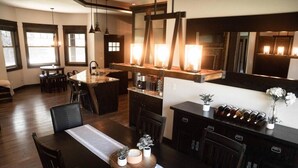 A modern kitchen with a central island, dark wood cabinetry, and a large mirror above the island.