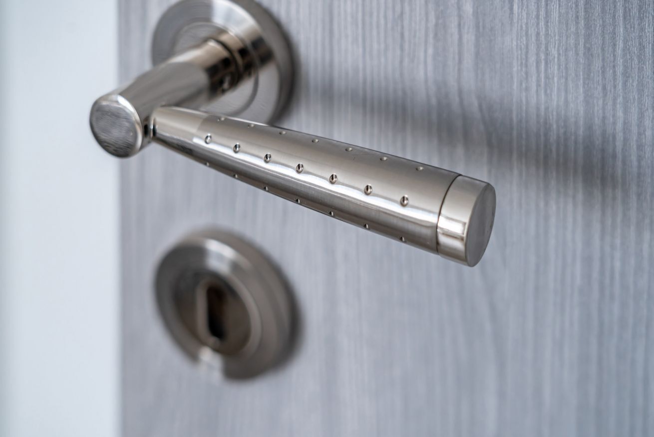 A metallic door handle with a keyhole.