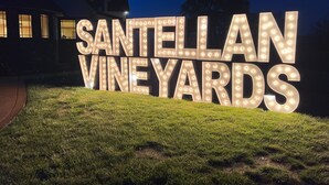 A large illuminated sign for Santellan Vineyards.