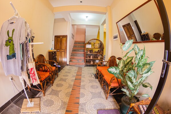 A spacious living area with a tiled floor, a staircase leading to another level, and a large potted plant. - Skylake (Copacabana)