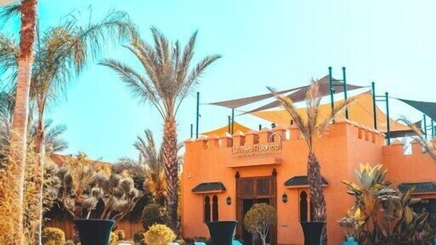 A pool area with lounge chairs and a building labeled "Aventura Resort." - Le Palais Averroes - Adults Only (Marrakech)