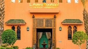 The entrance to L'Avero Rooftop with a traditional architectural style, featuring a tiled roof, ornate door, and a pathway leading to the entrance. - Le Palais Averroes - Adults Only (Marrakech)