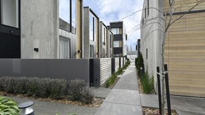 A modern residential area with uniform houses, narrow sidewalks, and minimal landscaping. - Worcester Terrace One -Top inner city location (Christchurch)