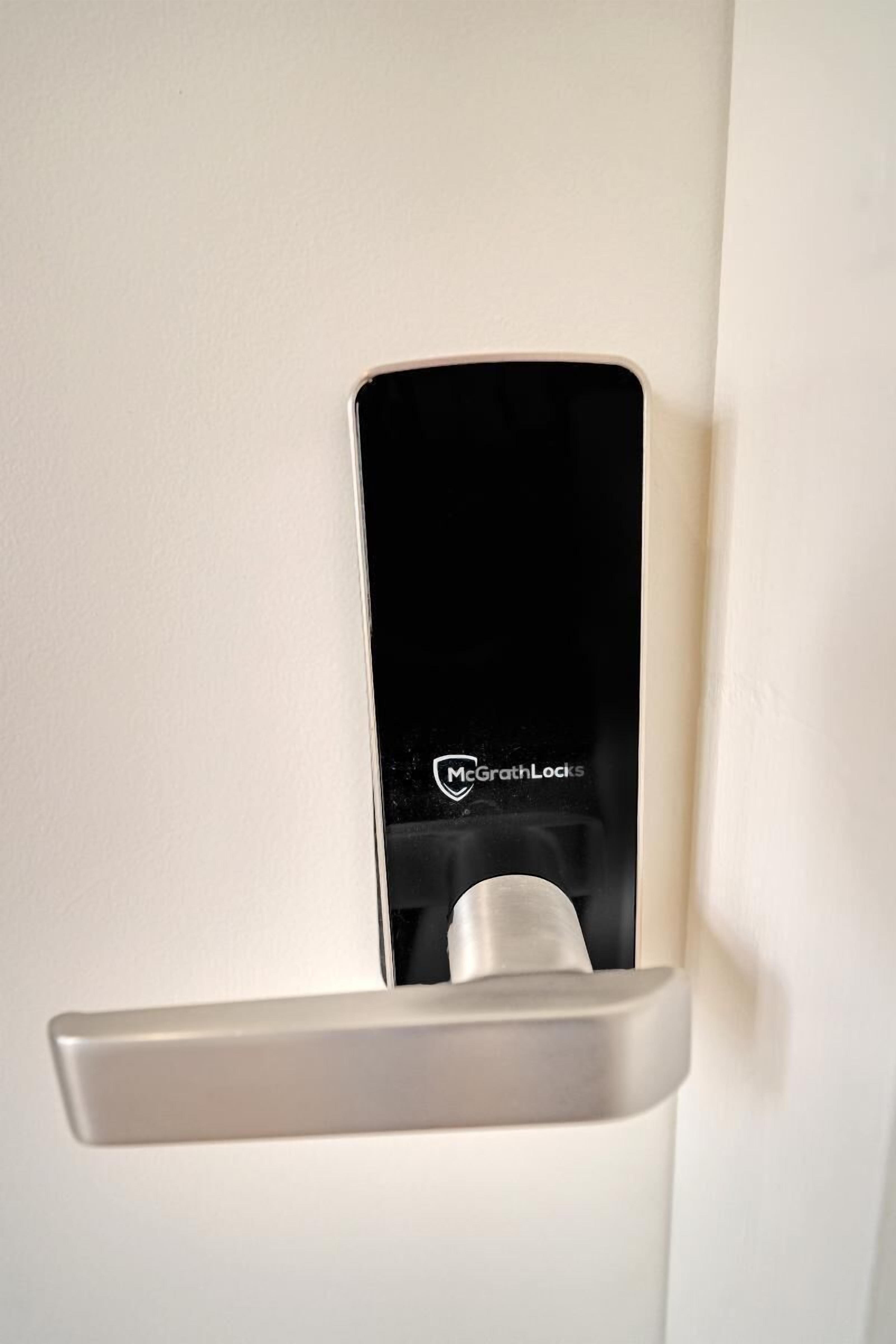 A modern door with a McGrath Locks electronic lock system.