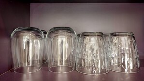 Quatre verres en verre transparent sont posés sur une table.