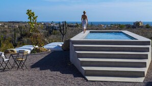 A person walking towards a pool with a view of the ocean and desert landscape. - Casa Santos (Todos Santos)