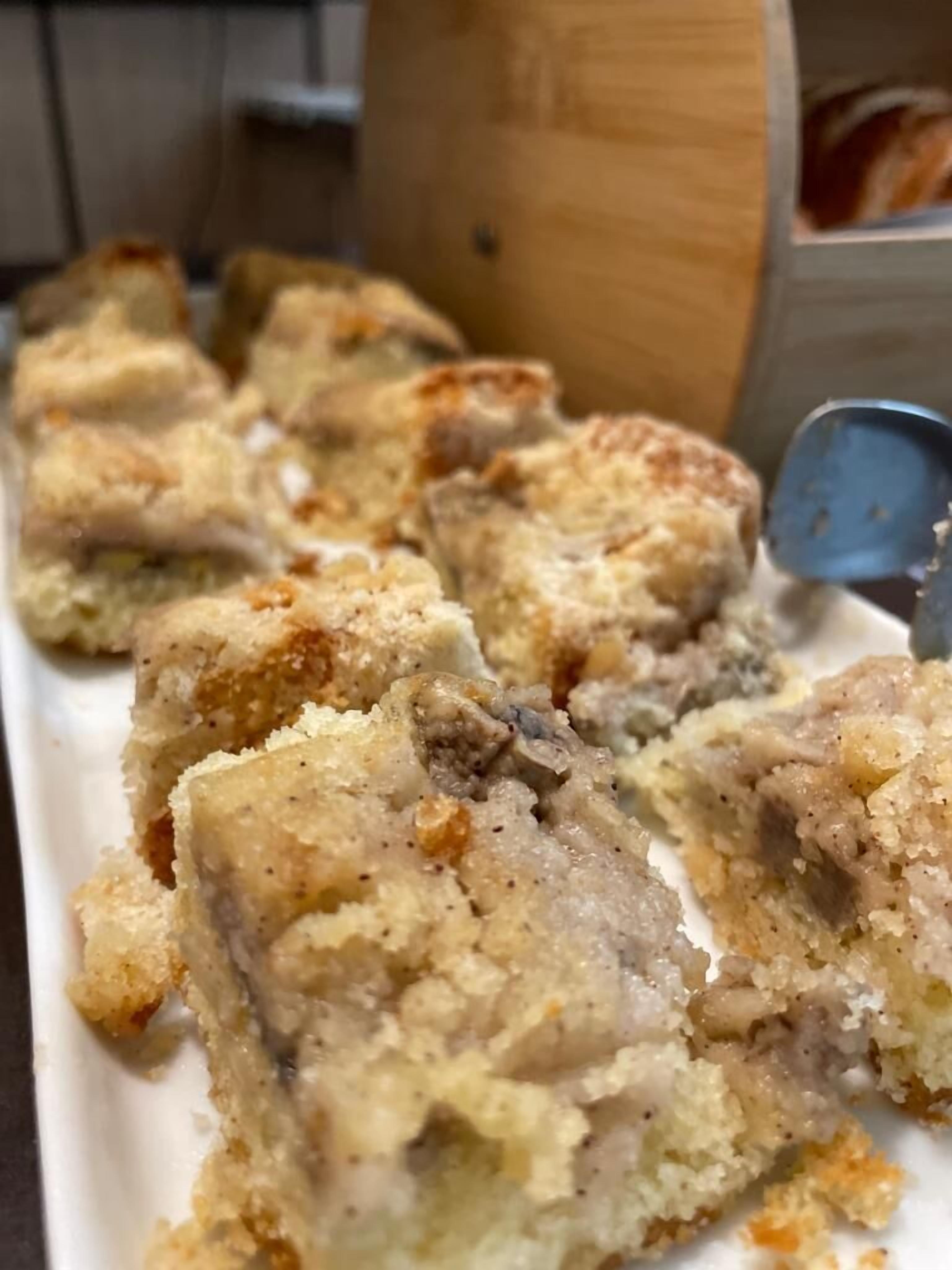 A tray of food with a crumbly texture, possibly a type of dessert or baked dish.