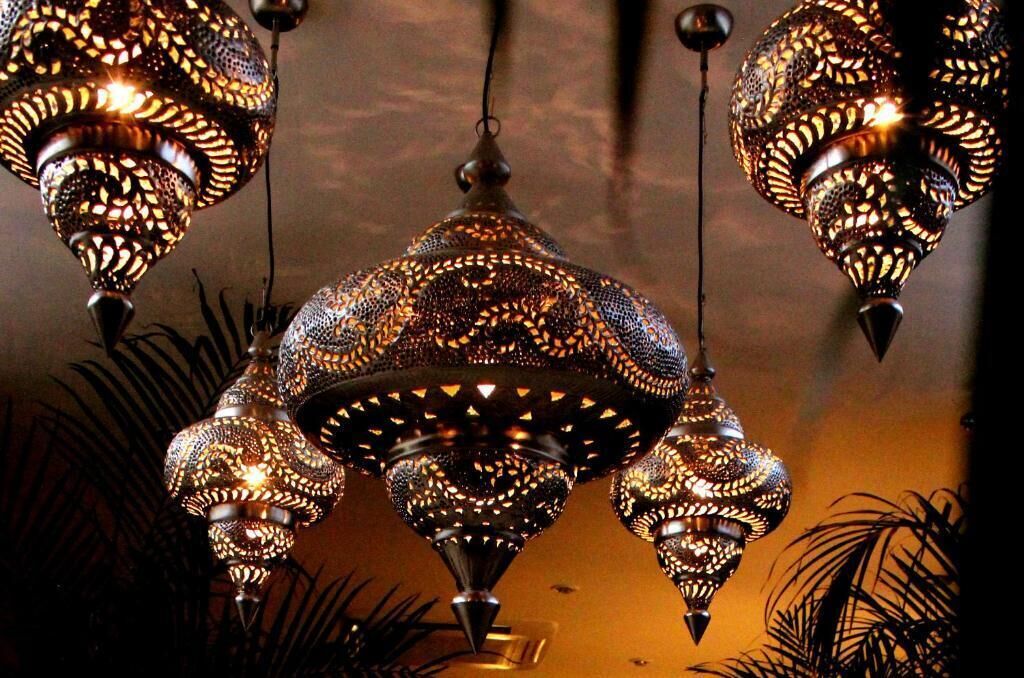 A chandelier with intricate metalwork and multiple hanging lamps.