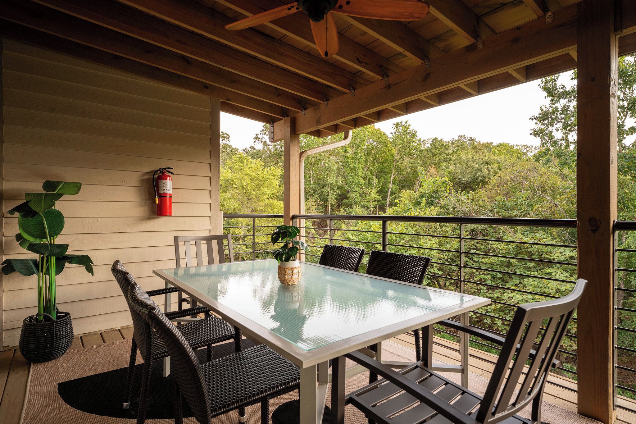 Deck dining table surrounded by trees