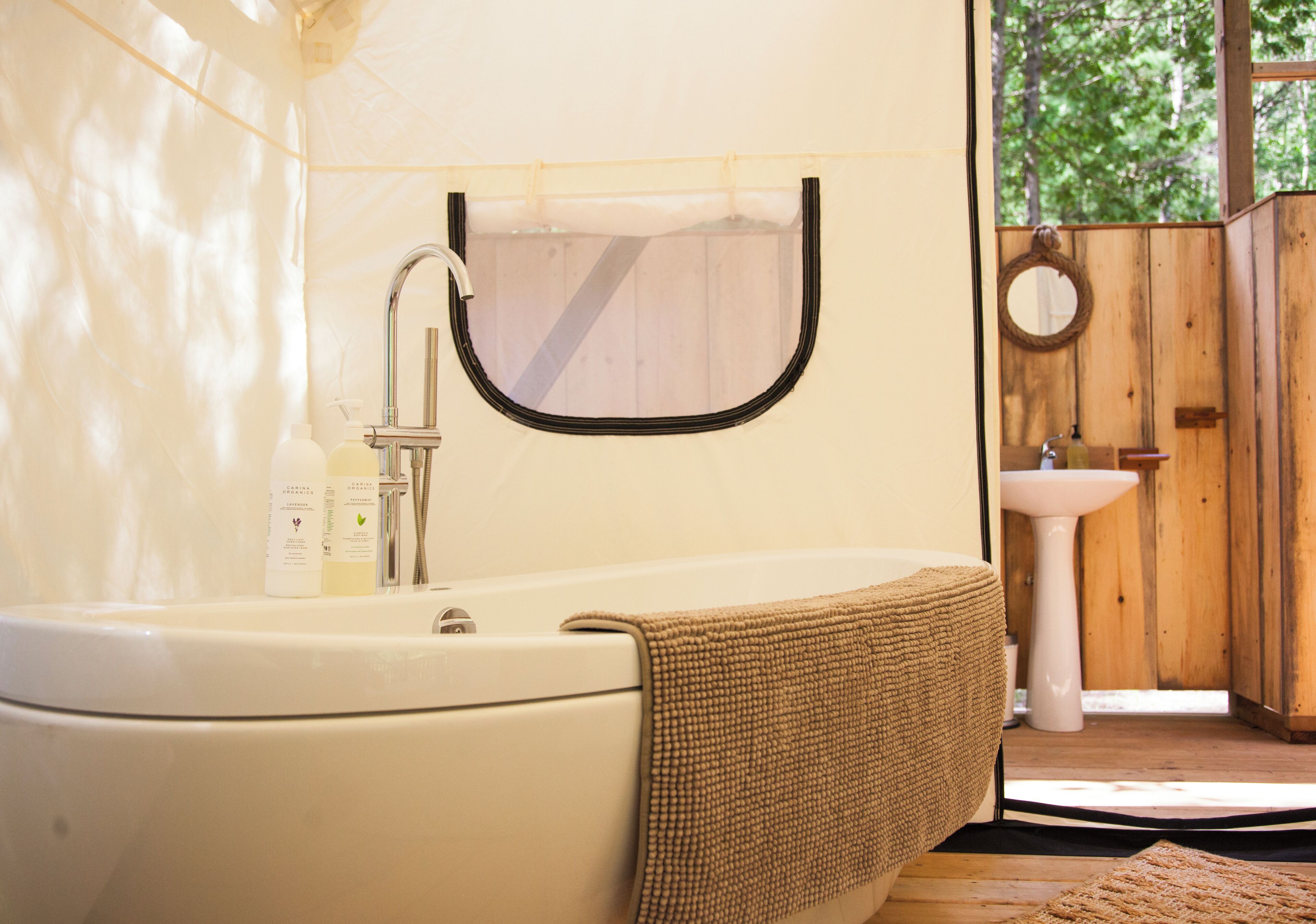 A bathroom with a white sink, a mirror, and a wooden door.